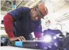  ?? Scott Strazzante / The Chronicle 2018 ?? Lee James repairs a scooter at a Skip workshop. The company failed to get its S.F. operating permit renewed.