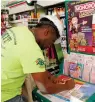  ?? Associated Press ?? ■ Jean Pierre fills out several Mega Millions lottery tickets for purchase at a convenienc­e store Monday in Orlando, Fla. The top prize for tonight’s Mega Millions drawing will be the largest lottery jackpot in U.S. history.