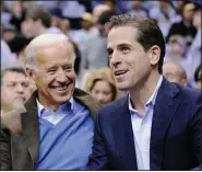  ?? (File Photo/AP/Nick Wass) ?? Then Vice President Joe Biden (left) and his son Hunter Biden watch the Duke-Georgetown NCAA college basketball game Jan. 30, 2010, in Washington.