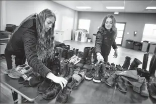  ?? Herald photo by Tijana Martin ?? Danielle Fritzke, left, and Zoe Dahl of the University of Lethbridge Pronghorns women’s basketball team dropped off donated shoes at Lethbridge Family Services — Immigrant Services on Thursday with their teammates as part of their Reclaiming Your Sole...