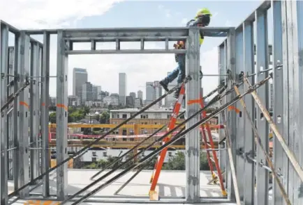  ?? Helen H. Richardson, The Denver Post ?? Denny Hilton, with MDA Constructi­on, works Wednesday on the ninth floor of the new Lydian apartment complex at 2560 Welton St. in Denver. It has 129 apartments, 15,000 square feet of office space and close to 10,000 square feet of retail space.