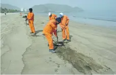  ?? Juman Jarallah / The National; Randi Sokoloff / The National ?? Top, oil washes ashore at Al Aqah, Fujairah, following last month’s spill caused by a tanker flushing out its hold. Above, workers from Sharjah Municipali­ty clean the beach after an oil slick off the east coast washed up in Khor Fakkan in February 2008