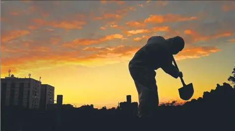  ??  ?? ■
DARK TIMES: A gravedigge­r is silhouette­d at sunset as he digs a grave for a Covid-19 victim at the Caju cemetery in Rio de Janeiro, Brazil.