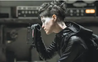  ?? Reiner Bajo / Columbia Pictures ?? Claire Foy is Lisbeth in “The Girl in the Spider’s Web,” not based on a book by Stieg Larsson.