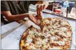  ?? Lisa Nichols / Hearst CT Media ?? Diners digging in to fresh pizza at Bar in New Haven.