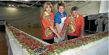  ??  ?? Cheryll Sotheran, Prime Minister Jenny Shipley and co-leader Cliff Whiting cut the world’s biggest pavlova to celebrate Te Papa’s first birthday in 1999.