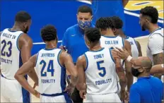  ?? Matt Freed/Post-Gazette ?? Pitt coach Jeff Capel talks to his team during a timeout as the Panthers take on the Saint Francis Red Flash on Nov. 25 at Petersen Events Center.