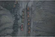  ??  ?? Bulldozers sit parked in a row in this aerial photograph taken above the Peabody Energy Somerville Central coal mine in Oakland City, Indiana.