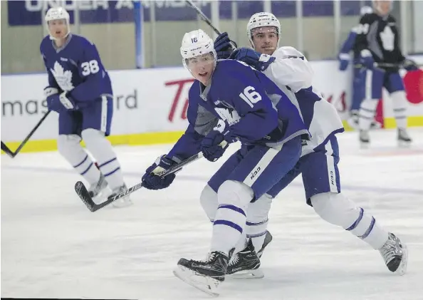  ?? THE CANADIAN PRESS ?? Toronto Maple Leafs’ Mitch Marner, left, skates with veterans Brooks Laich and Colin Greening at training camp in Halifax.