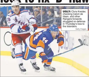  ?? Getty Images ?? UGLY: Chris Kreider, checking Calvin de Haan, and other Rangers forwards struggled on defense in Thursday’s loss to the Islanders.