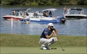  ?? ERIC GAY — THE ASSOCIATED PRESS ?? Dustin Johnson lines up a putt on the 14th hole as fans watch from boats on Lake Austin during quarterfin­al play at the Dell Technologi­es Match Play golf tournament at Austin County Club, Saturday in Austin, Texas.