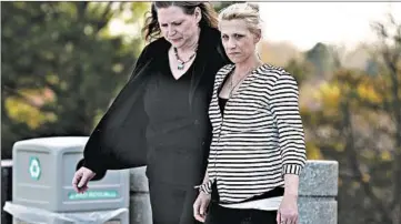  ?? TERRENCE ANTONIO JAMES/CHICAGO TRIBUNE ?? JoAnn Cunningham, right, the mother of Andrew “AJ” Freund, walks outside the McHenry County Courthouse last week.