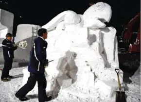  ?? AFP ?? Sculptors from Thailand work on their creation ‘Future In Our Hand’ during the internatio­nal snow statue contest at the Sapporo Snow Festival in Sapporo.