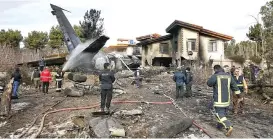  ?? (AFP) ?? Firefighte­rs and security forces gather amidst the debris of a Boeing 707 cargo plane on Monday