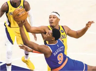  ?? DOUG MCSCHOOLER AP ?? Knicks guard RJ Barrett (9), who had a team-high 25 points, drives to the basket as Pacers forward Myles Turner tries to block his shot during the second half Saturday in Indianapol­is.