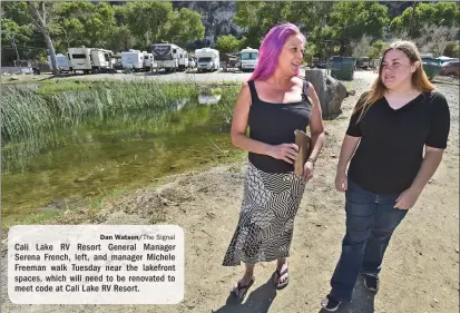  ?? Dan Watson/The Signal ?? Cali Lake RV Resort General Manager Serena French, left, and manager Michele Freeman walk Tuesday near the lakefront spaces, which will need to be renovated to meet code at Cali Lake RV Resort.