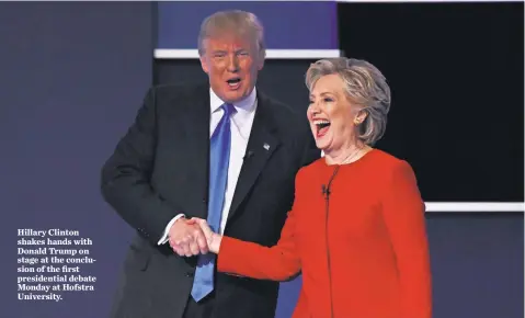  ?? ROBERT DEUTSCH, USA TODAY ?? Hillary Clinton shakes hands with Donald Trump on stage at the conclusion of the first presidenti­al debate Monday at Hofstra University.