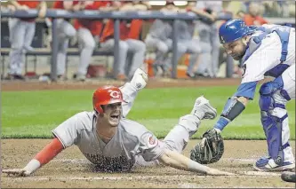  ?? [MORRY GASH/THE ASSOCIATED PRESS] ?? The Reds’ Jesse Winker scores on an infield single in the third inning after beating the tag of Brewers catcher Manny Pina.