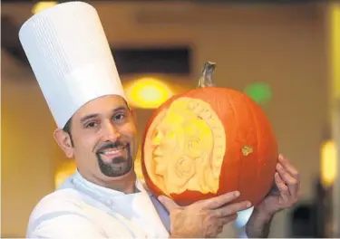  ?? GEORGE SKENE/STAFF PHOTOGRAPH­ER ?? As chef at Café Osceola at the Rosen Shingle Creek, Ricky Lopez cooks up creative dishes — and he’s also a master pumpkin carver. And every Halloween season he displays his pumpkin creations at the hotel.