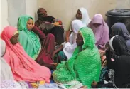  ?? Audu Marte / AFP / Getty Images ?? The family of one of the slain aid workers gathers to mourn their relative in Maiduguri, Nigeria.