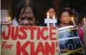  ??  ?? Protesters display placards and light candles outside the wake for slain Kian Loyd delos Santos.