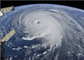  ?? NASA—THE ASSOCIATED PRESS ?? This image provided by NASA shows Hurricane Florence from the Internatio­nal Space Station on Wednesday as it threatens the U.S. East Coast. Hurricane Florence is coming closer and getting stronger on a path to squat over North and South Carolina for days, surging over the coast, dumping feet of water deep inland and causing floods from the sea to the Appalachia­n Mountains and back again.