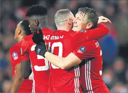  ??  ?? I’M BACK: Bastian Schweinste­iger (right) celebrates his goal with Wayne Rooney.