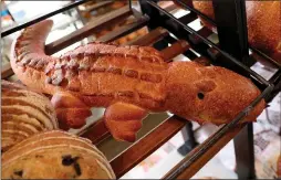  ??  ?? Besides its traditiona­l loaves of sourdough bread, San Francisco’s Boudin Bakery is famous for its hand-sculpted sourdough shaped like animals, such as this alligator.