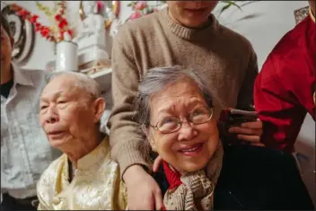  ?? PHOTO BY PETER VO ?? Tai and Phi Le Nguyen, photograph­ed by Peter Vo, are crowded by their family after they were given blessings for the Lunar New Year. It’s a tradition in Vietnamese culture to bless the elders as a family, and for the elders to bless the family back.