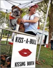  ?? DIGITAL FIRST MEDIA FILE PHOTO ?? George, an English bulldog, waits to give someone a sloppy kiss at the Lenape Bulldog Club booth with Traci Loper at the annual Pottstown Pet Fair.