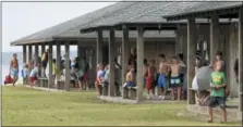  ?? GRAY WHITLEY — SUN JOURNAL VIA ASSOCIATED PRESS, FILE ?? Children gather at their respective cabins and get ready for the day’s activities during a four-week summer camp session at Camp Sea Gull near Arapahoe, N.C. About 90 percent of the nearly 8,400 sleep away camps counted by the American Camp Associatio­n are now device free, though some allow limited time with screenless iPods and other internet-free music players.