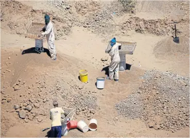  ?? /Reuters ?? Hard ground: Illegal diamond miners at work in Kimberley. Minerals minister Gwede Mantashe says informal mining must be brought from the periphery into the mainstream of mining.