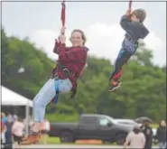  ?? PETE BANNAN — DIGITAL FIRST MEDIA ?? Katie Carroll and her son Jackie, 7, ride the zip line during the 12th Annual Chester County Balloon Festival.