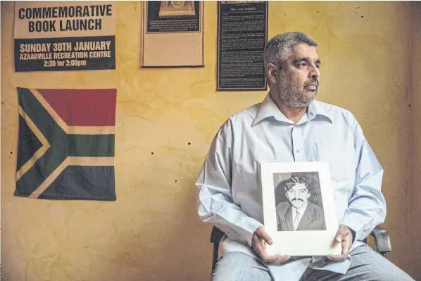  ??  ?? CHAMPIONIN­G THE CAMPAIGN FOR TRUTH: Imtiaz Cajee, the nephew of Ahmed Timol, an anti-apartheid activist brutally murdered in police custody in October 1971, holds a portrait of his uncle at his house in Pretoria.