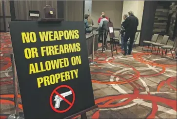  ?? Scott Sonner Associated Press ?? FIREARMS ARE prohibited during a 2018 event for the Independen­t American Party in Sparks, Nev. This year, states hoping to prevent voter intimidati­on are researchin­g how to balance their gun rights with safety.