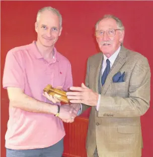  ??  ?? Pictured, James Gibson presenting Mark Harrison with the Best Topic award at a meeting of the Loughborou­gh Speakers Club