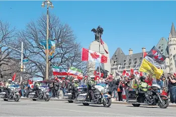  ?? ?? POLICE PRESENCE: Motorcyle police pass one of the demonstrat­ions in Ottawa.