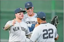  ?? KEVIN M. COX/AP PHOTO ?? New York Yankees left fielder Alex Verdugo, left, center fielder Aaron Judge and right fielder Juan Soto (22) celebrate after an opening-day win over the Houston Astros on Thursday in Houston.