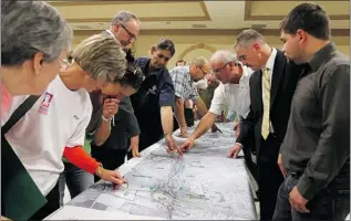  ?? TYLER BROWNBRIDG­E/The Windsor Star ?? Members of the public learn about traffic circles Thursday at the Macedonian Centre. The roundabout, part of the Parkway project, is the latest in a growing number being built across Ontario.
