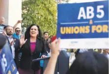  ?? Photos by Rich Pedroncell­i / Associated Press ?? Assemblywo­man Lorena Gonzalez (center) wrote AB5, which would turn gig workers into company employees.