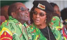  ??  ?? Former Zimbabwe President Robert Mugabe and his wife Grace during a youth rally in Marondera Zimbabwe in July.