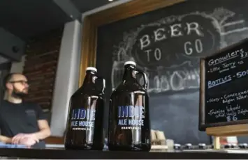  ?? RICHARD LAUTENS/TORONTO STAR ?? India Ale House Brewing employee Geordie Gordon oversees the counter where Growlers are for sale.