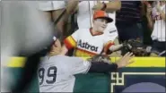  ?? TONY GUTIERREZ — ASSOCIATED PRESS ?? A young fan catches a home run hit by Astros’ Carlos Correa in front of Yankees’ Aaron Judge in the fourth inning of Saturday’s game in Houston.