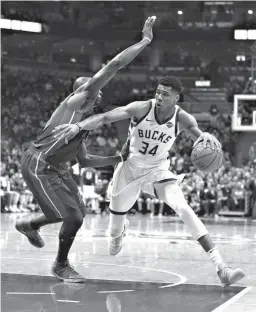  ?? Associated Press ?? Milwaukee Bucks' Giannis Antetokoun­mpo (34) drives to the basket against Detroit Pistons' Anthony Tolliver during the second half of an NBA basketball game Wednesday in Milwaukee. The Bucks won, 99-95.