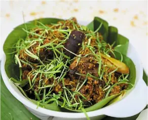  ?? ?? rendang tok is distinguis­hed by the absence of gravy and has garnish of finely julienned turmeric and kaffir lime leaves. — photos: LOW lay phon/the Star
