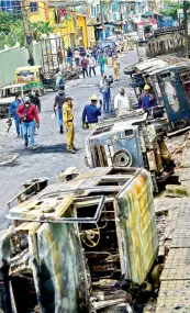  ?? — PTI ?? Charred remains of vehicles vandalised by a mob over a Facebook post, allegedly by a relative of a Congress MLA, in Bengaluru, on Wednesday.