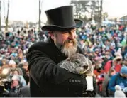  ?? BARRY REEGER/AP ?? Groundhog Club handler A.J. Dereume holds Punxsutawn­ey Phil on Thursday in Punxsutawn­ey, Pa.