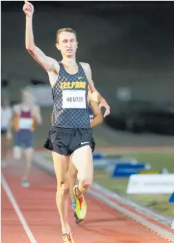  ?? Photos / Stuart Munro ?? Canberra’s Rorey Hunter raises his hand after winning the One Mile Championsh­ip at the Sir Peter Snell Internatio­nal Track Meeting at Cooks Gardens on Saturday night.