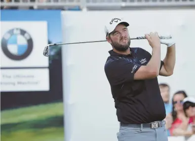  ?? AP PHOTO ?? IN THE SWING: Marc Leishman watches his tee shot on the 17th hole during yesterday’s third round of the BMW Championsh­ip at Conway Farms Golf Club in Lake Forest, Ill.