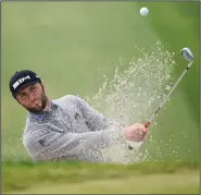  ?? (AP/Denis Poroy) ?? Jon Rahm hits his tee shot on the 14th hole of the South Course at Torrey Pines Golf Course during the third round of the Farmers Insurance Open on Saturday in San Diego. Rahm shot a 7-under 65 for a one-shot lead over Ryan Palmer.